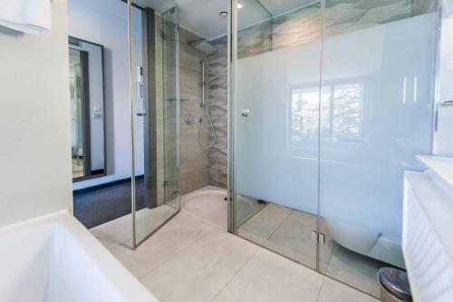 a bathroom with a shower and a glass shower stall at Hotel Arupinum in Rovinj