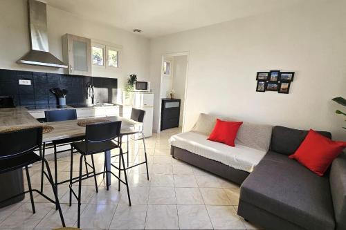 a living room with a couch and a table and a kitchen at Beautiful T2 - close to the sea in La Seyne-sur-Mer