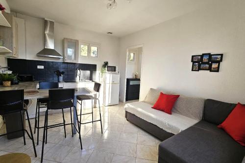 a living room with a couch and a kitchen at Beautiful T2 - close to the sea in La Seyne-sur-Mer