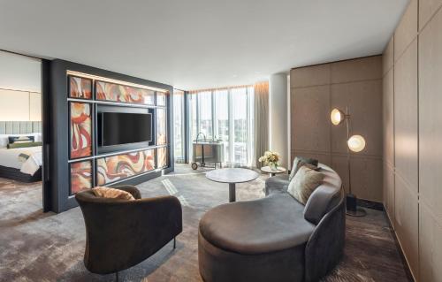 a living room with a couch and a tv at The Darling at The Star in Sydney