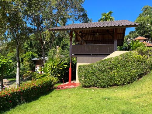 a building with a gazebo in a park at Koh Mak Buri Hut Natural Resort in Ko Mak