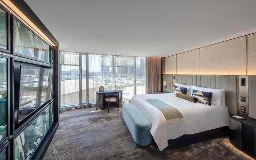 a hotel room with a bed and a large window at The Darling at The Star in Sydney