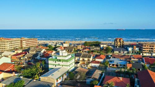 an aerial view of a city and the ocean at Tropical Tramandaí in Tramandaí