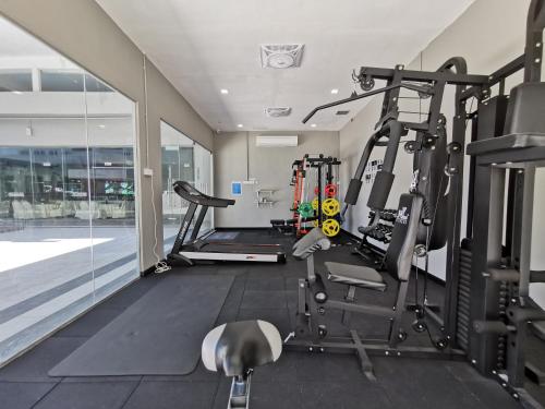 a gym with several tread machines in a room at Langkasuka Express in Kuah