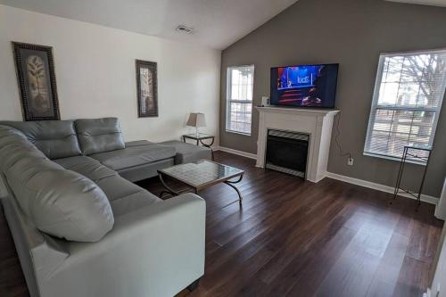 a living room with a couch and a fireplace at Haven - Uptown/Airport Corridor in Charlotte