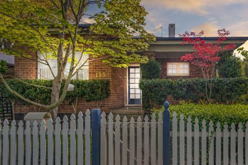 a white picket fence in front of a house at Heritage on Hill - Refreshing Elegance in Orange