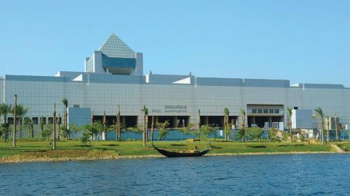 a boat in the water in front of a building at InterContinental Cairo Semiramis by IHG in Cairo