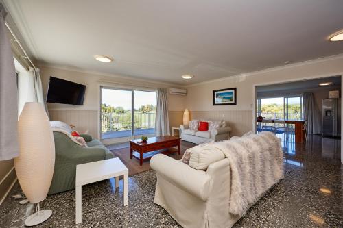 a living room with a couch and a table at Kakatu Retreat Bed & Breakfast in Kaikoura