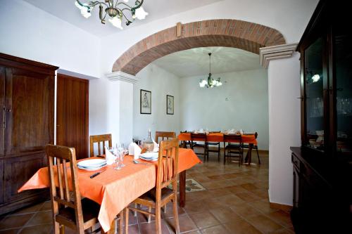 a dining room with a table with orange table cloth at Agriturismo Miracco Atanasio Franco "Il Maniero" in Santa Sofia dʼEpiro