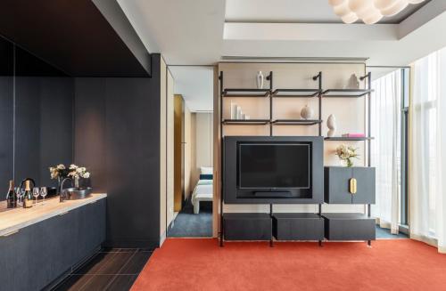 a living room with a television and shelves at The Darling at The Star in Sydney