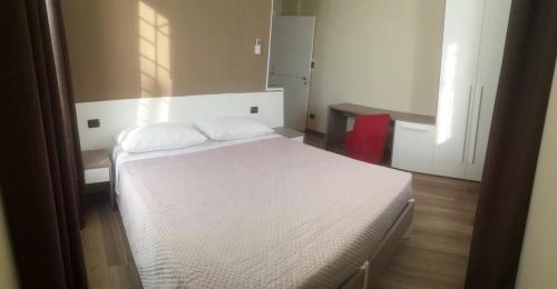 a bedroom with a white bed in a room at Locanda Ai Due Orsi in Milan