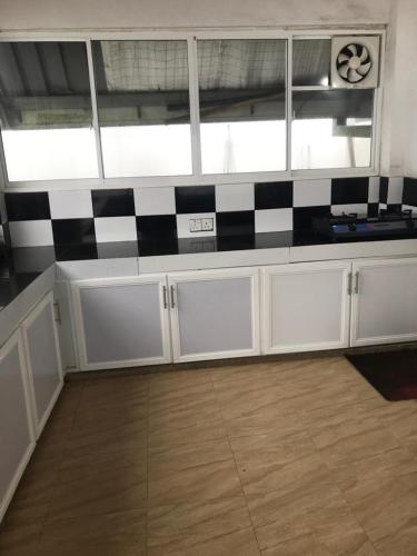 a kitchen with black and white checkered counter top at White house in Nuwara Eliya