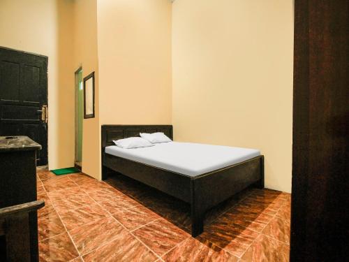 Кровать или кровати в номере Hotel O Emmy Homestay Syariah