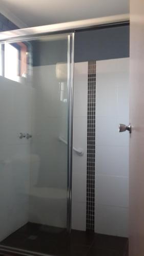 a shower with a glass door in a bathroom at Zero Inn Motel in Nhill
