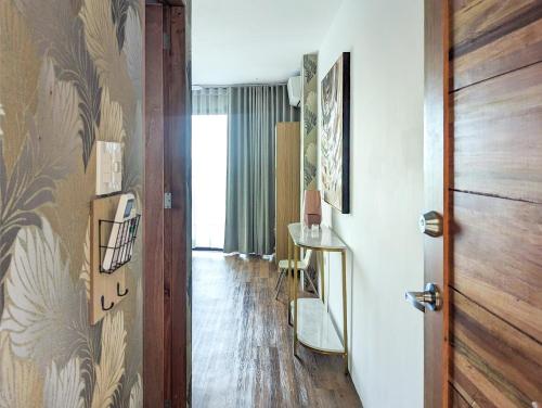 a hallway with a door and a room with a table at Ponderosa Golf and Resort in Puerto Galera