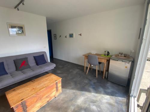 a living room with a couch and a table at Pukeatua Farmstay in Waimauku