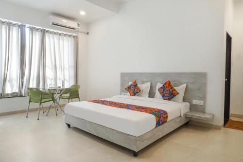 a bedroom with a bed and a table in it at FabHotel Irra Executive in Pune
