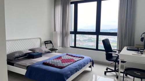 a bedroom with a bed and a desk with a computer at Fully furnished Studio Unit. in Sungai Buluh