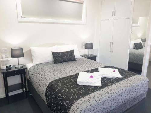 a bedroom with a bed with two towels on it at Comfort Inn May Park in Horsham