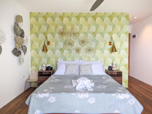 a bedroom with a bed with a green wall at Ponderosa Golf and Resort in Puerto Galera