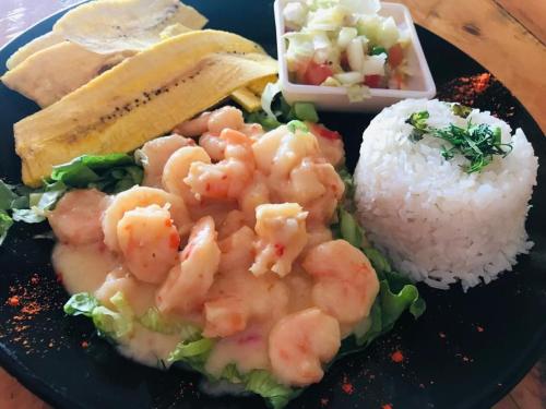 a plate of food with shrimp and rice on a table at Habitacion en La Vie en Rose in Cartagena de Indias