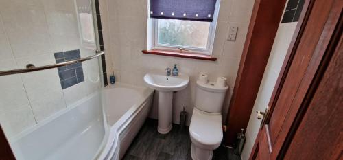 a bathroom with a toilet and a sink and a shower at Grafton House in Martlesham