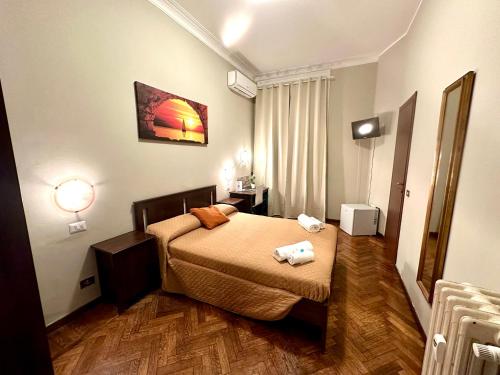 a hotel room with a bed with two towels on it at Carlo Goldoni Hotel in Milan