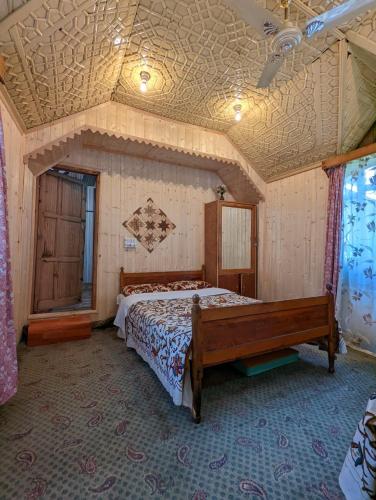 a bedroom with a bed and a coffered ceiling at Golden Hopes Group of Houseboats in Srinagar