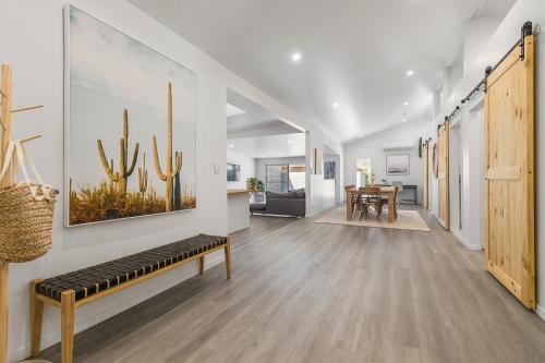 a living room with a bench and a dining room at The Bunker- 24 Straight Street HAT HEAD in Hat Head