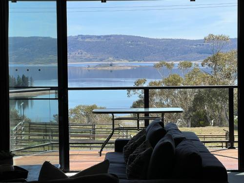 a living room with a view of a lake at Stockyards 2, Jindabyne in Jindabyne
