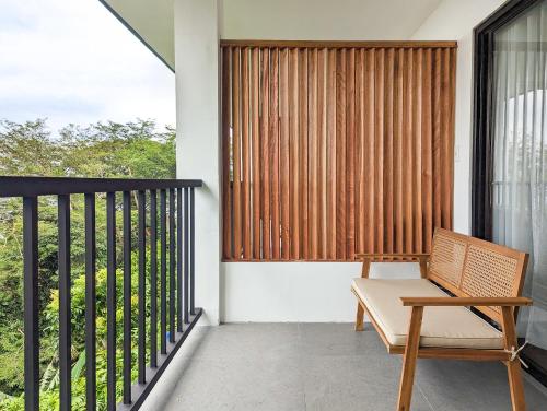 a balcony with a bench and a window at Ponderosa Golf and Resort in Puerto Galera