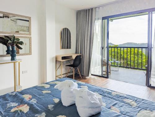 a bedroom with two stuffed animals sitting on a bed at Ponderosa Golf and Resort in Puerto Galera