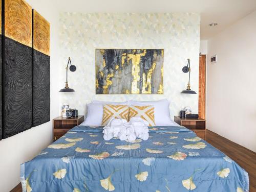 a bedroom with a blue bed with towels on it at Ponderosa Golf and Resort in Puerto Galera