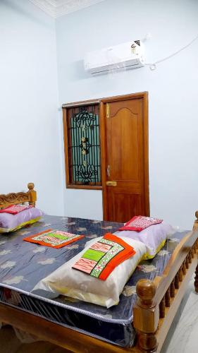 a room with a table with two pillows on it at adhirai's home stay in Pondicherry