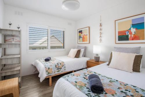 a bedroom with two beds and a window at Mingara Two - oceanstays in Yamba