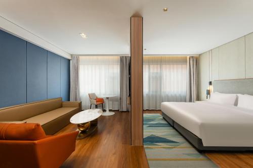a hotel room with a bed and a couch at Holiday Inn Express Lanzhou Zhengning Road, an IHG Hotel in Lanzhou