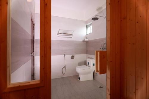 a bathroom with a toilet and a shower at Hotel Eco Tree Pokhara in Pokhara