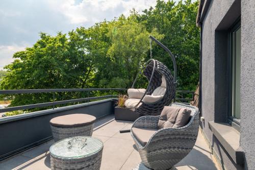 a balcony with two chairs and a swing at Sellmann´s Boutique Hotel in Dortmund