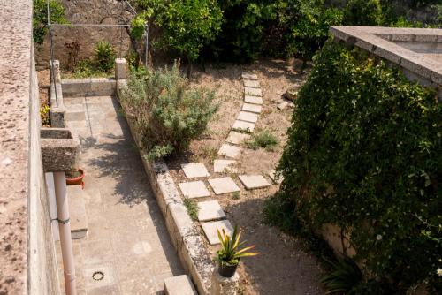 a garden with a stone pathway and plants at Corte Delle Moline in San Cesario di Lecce