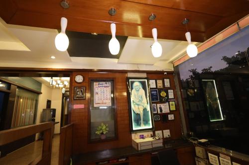 a restaurant with lights hanging from the ceiling at Hotel Sai Grand Castle Inn in Shirdi