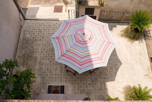 an overhead view of an umbrella in front of a building at Corte Delle Moline in San Cesario di Lecce