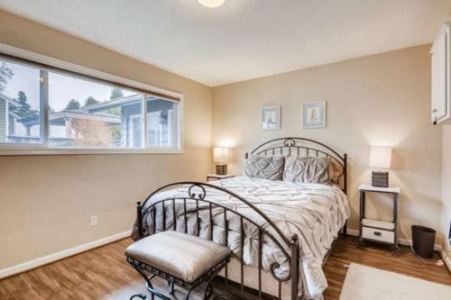 a bedroom with a bed and a large window at Beautiful 2 Bedroom Unit w/ FAST FREE WIFI in Beaverton