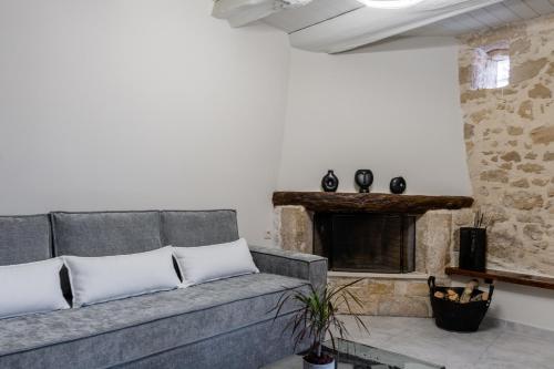 a living room with a couch and a fireplace at Athali villa in Krousón