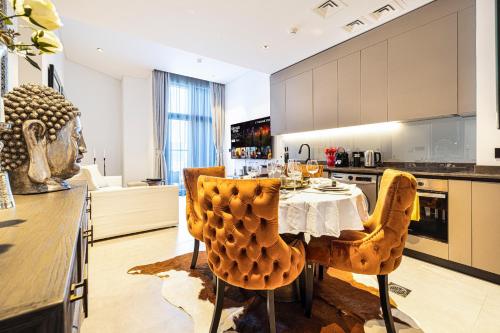 a kitchen with a table and two yellow chairs at The Suite Dubai 15 Northside Luxury Living in Dubai