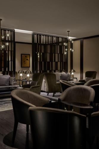 a lobby with chairs and tables and a library at JW Marriott Kuala Lumpur in Kuala Lumpur