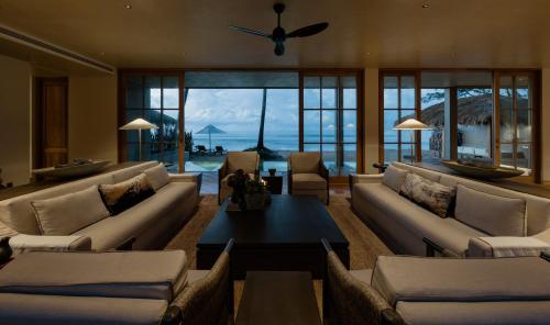 a living room with couches and a table at The Six Weligama in Weligama