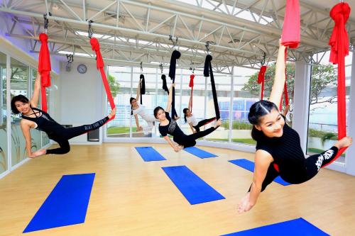 a group of people doing yoga in a gym at Centara Grand At CentralWorld in Bangkok