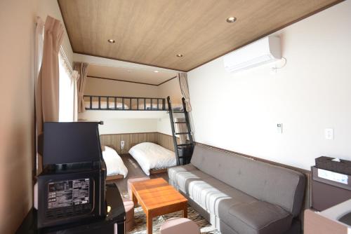 a living room with a couch and a bunk bed at Mt Fuji Glamping VILLA Kawaguchiko in Fujikawaguchiko