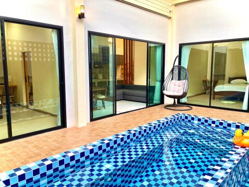 a swimming pool in the middle of a house at Cozy Private Pool Villa For Family - Halal in Ban Thalat Choeng Thale