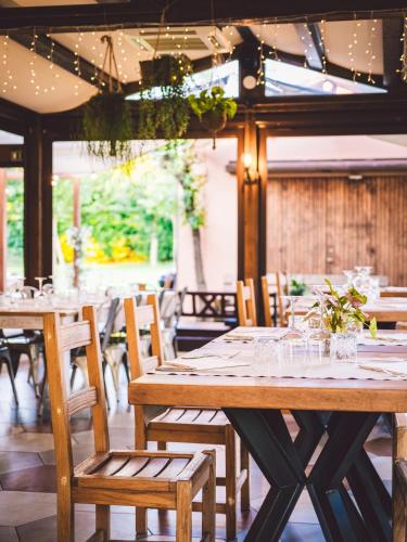 a dining room with wooden tables and chairs at Due Ponti Village in Cesenatico